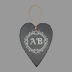 A dark gray slate heart-shaped wall hanging with a natural jute loop at the top.