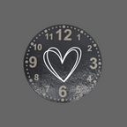 A round black clock face with distressed texture, featuring numbers, a central outlined double-heart motif, and small dots around the outer edge, shown on a plain white background.