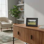 A rectangle black picture frame with a small inset photograph of a  outdoor scene.