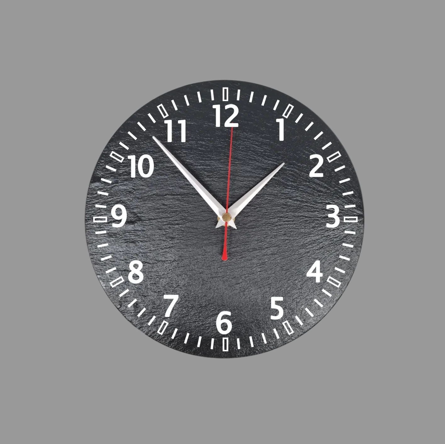 A round black slate wall clock with numerals, silver hands, and a red second hand, shown against a light gray background.