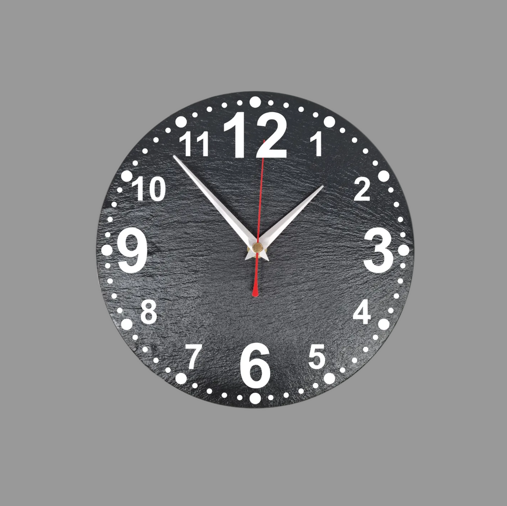 A round black slate wall clock with numerals, silver hands, and a red second hand, shown against a solid gray background.