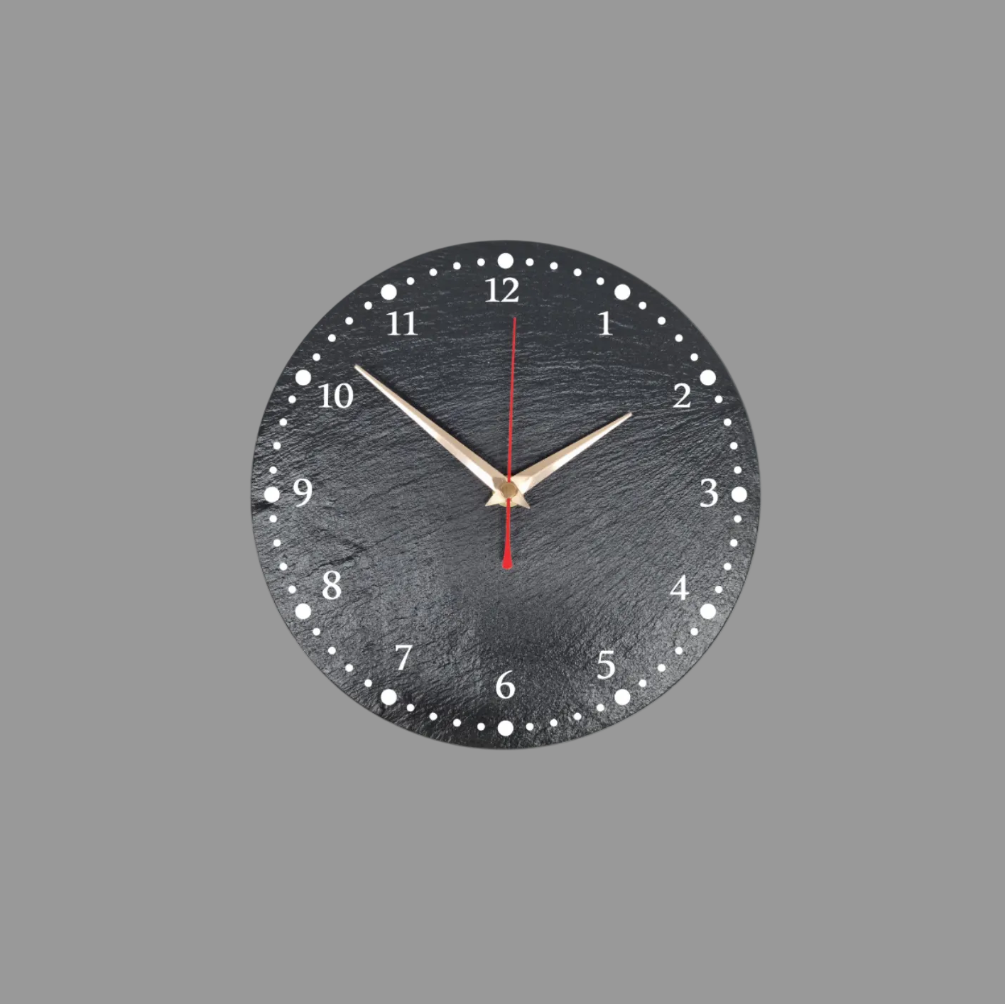 A round black slate wall clock with numerals, white dot hour markers, gold-tone hands, and a red second hand, shown against a light gray background.