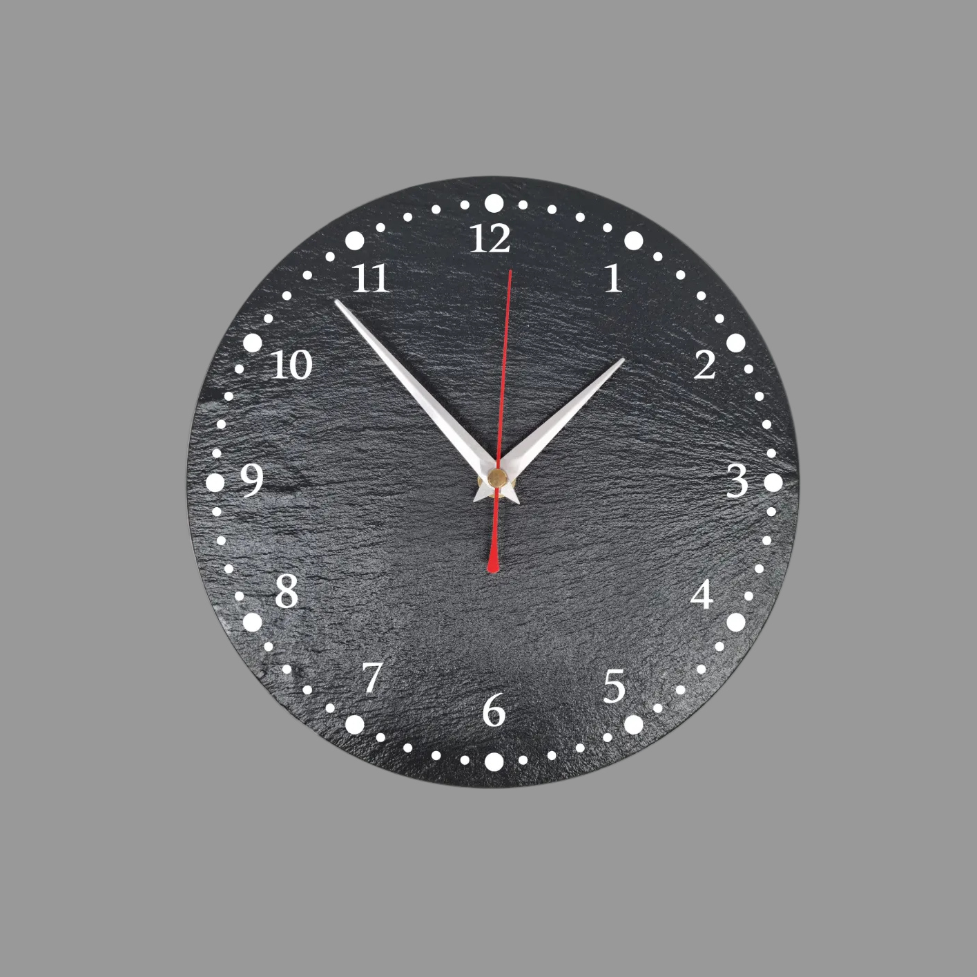 A round black slate wall clock with numerals, silver hands, and a red second hand, shown against a solid gray background.