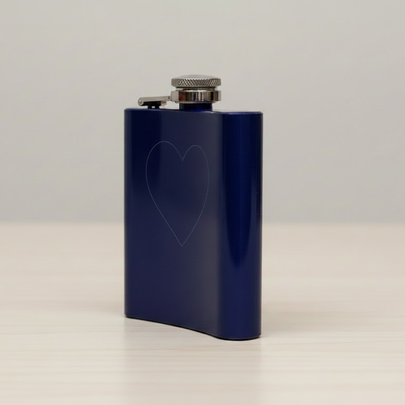 A blue flask with a silver screw cap, featuring an engraved design   viewed from the side.
