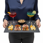A rectangular black slate serving tray with two silver metal handles.